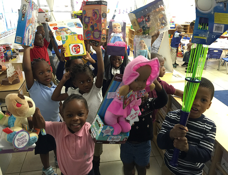 Children at the Notre Dame Child Development Center show off their new toys.