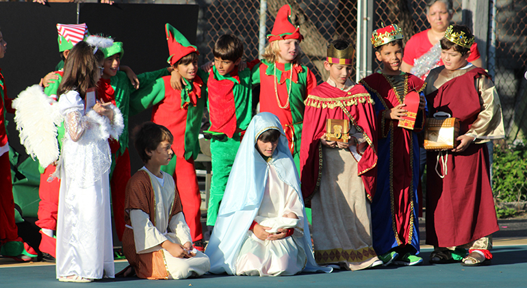 A Christmas Nativity scene, with some of Santa's elves in the background, is a must during the Christmas play performed by third graders from Sts. Peter and Paul School during their Christmas around the world-themed STREAMS Day.