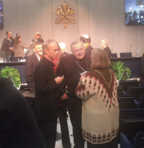 Archbishop Thomas Wenski speaks with journalists after the press conference on climate change at the Holy See.