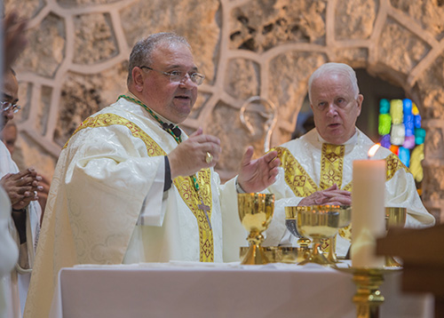 Bishop Peter Baldacchino and Father Bernard Kirlin, St. Mary Magdalen's pastor, celebrate the anniversary Mass.