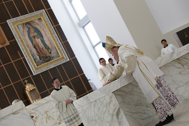 Archbishop Thomas Wenski anoints the altar of Our Lady of Guadalupe Church with the Oil of Chrism.