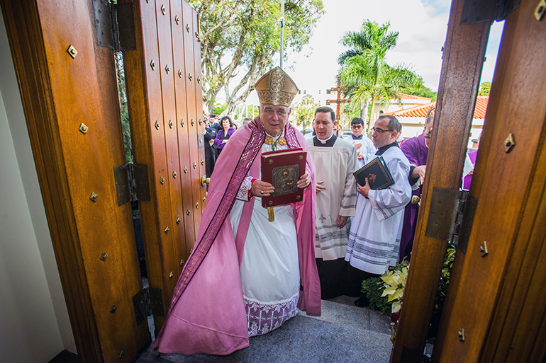 Archbishop Thomas Wenski enters through the Holy Door at St. Mary Cathedral.