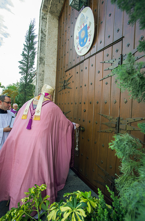 Archbishop Thomas Wenski opens the Holy Door at the northwest entrance to St. Mary Cathedral.