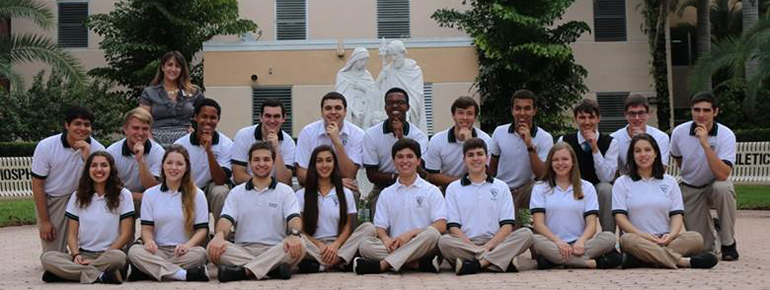 Sitting before the Holy Family statue donated by the 2002 inaugural class are Archbishop Edward A McCarthy High School students recognized in 2016 for their academic achievements by the National Merit Recognition Program and the National Hispanic Recognition Program. Sitting, from left: Veronica Roach, Lara Suarez, Alessandro Benadia, Monica Diaz, Andres De La Fe, Alec Arritola, Jenna Tingum, Rebecca Vargas. Kneeling, from left: Sebastian Fuentes, Alexander Smith, Savaughn Cannady, Alejandro De La Cova, Daniel Soto, Jonathan Delva, John Albury, Michael Perez, Matthew Salas, Andres Samos and Ronald Geis. Standing behind themn is Adriana P. Murgueytio, director of Guidance and Counseling at McCarthy High.