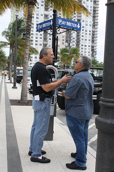 St. Paul Street Evangelization member, David Babbin, left, spreads the Gospel message to a receptive pedestrian.