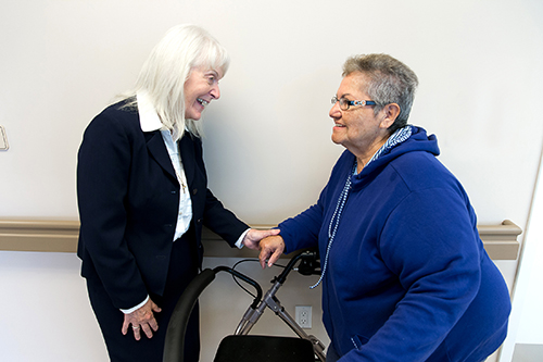 Sister Jill Bond, left, vice-president of Mission Advancement for Catholic Health Services, speaks with Nilda Fuentes following the Jan. 12 blessing and dedication of St. Joseph Manor Independent Living Facility, an archdiocesan-sponsored housing facility for low-income elderly in Pompano Beach.
