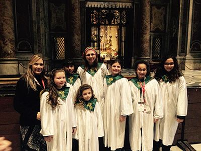 Members of St. David's choir pose for a photo at St. Peter's Basilica. Pictured are choir director Mary Waxman, Kristen Mestre, Rachel Alston, Alexandra Leon, Emily Giovino, Victoria Post, Catalina Esteban and Jo Anna Harrison, who graduated from St. David's five years ago. She went to Rome back then as an eighth grader.