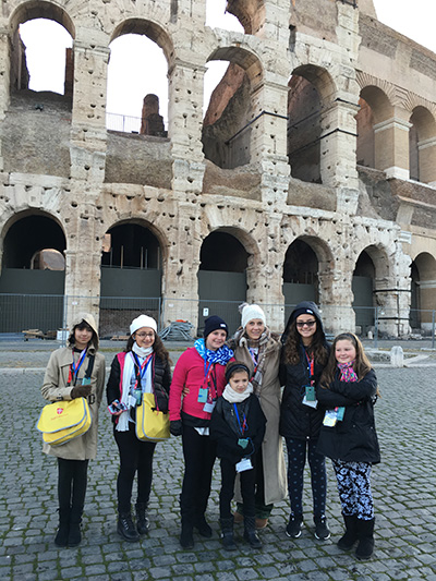 Members of St. David's choir pose for a photo outside the Coloseum.