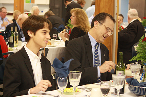 St. Malachy parishioners Juan Fernandez, left, and his father, Jose Fernandez, enjoy their meal at the banquet held by the parish's pro-life ministry held on the feast of the Immaculate Conception.