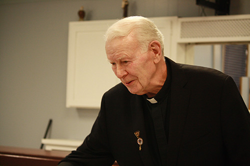 St. Malachy's pastor and prolife champion, Father Dominic O'Dwyer, greets guests at the annual banquet held by the parish's pro-life ministry.