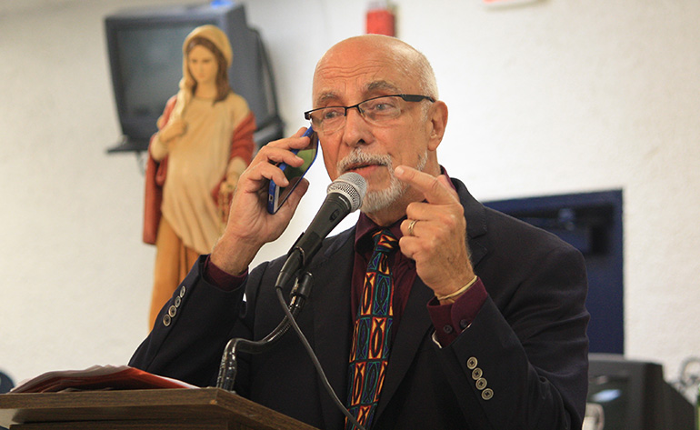 Christian Action News publisher and keynote speaker, Edward Daccarett, illustrates a hypothetical phone call from Jesus to God the Father during his talk at St. Malachy's annual pro-life life banquet.