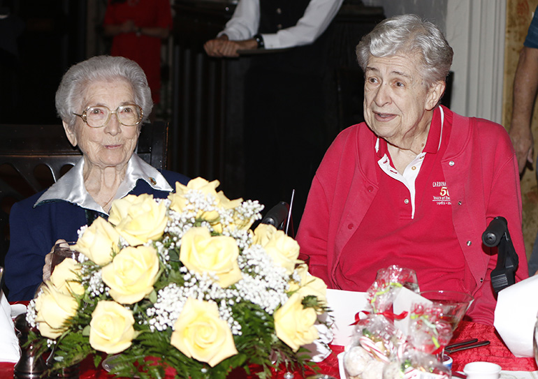 Franciscan Sister Marie Schramko, left, and Sister Janet Rieden, humbly accept accolades from Cardinal Gibbons faculty and staff at their retirement and farewell luncheon. They have served at the school for more than 50 years.