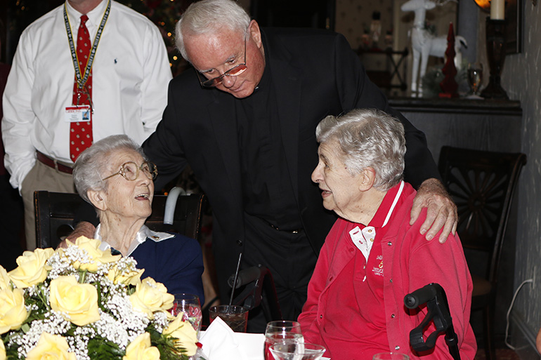Msgr. Vincent Kelly, supervising principal at Cardinal Gibbons High School, says goodbye to Sister Marie Schramko, 98, left, and Sister Janet Rieden, 82, who have worked at the school for more than 50 years. He began working with them in 1969 and praised their approach to the education of young people. "Their Franciscan theme of love and mercy and respect will influence many of these students as they journey through life."