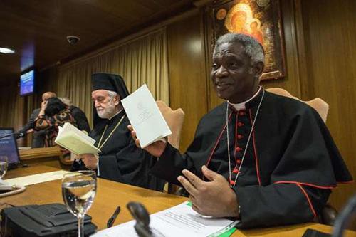 Cardinal Peter Turkson, right, introduces Pope Francis' encyclical "Laudato Si at a press conference in June in Vatican City. Behind him is Orthodox Metropolitan of Pergamo John Zizioulas. Cardinal Turkson will be speaking at St. Thomas University Feb. 18 and 19.