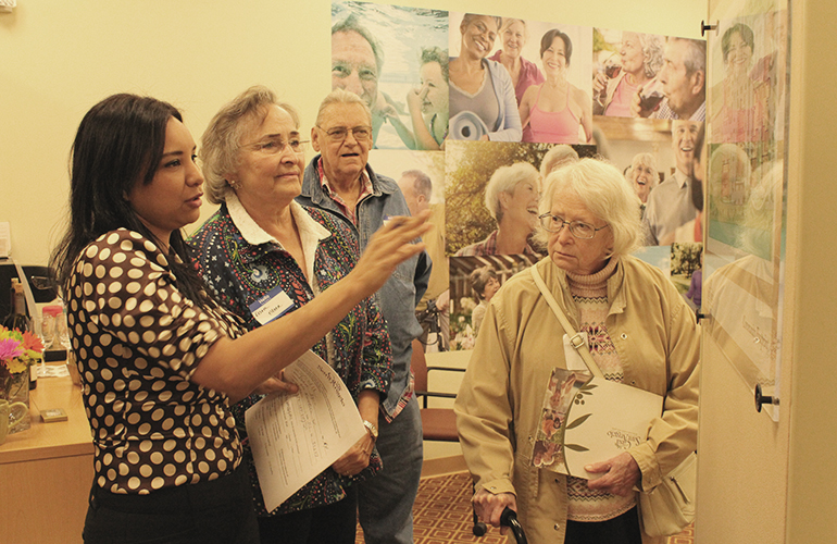 Angela Varela (far left) explains the layout of Casa Sant'Angelo on the St. John XXIII Church grounds to Dora Olsen (second from the left), her husband Lynne and cousin Renee Sweisthal.
