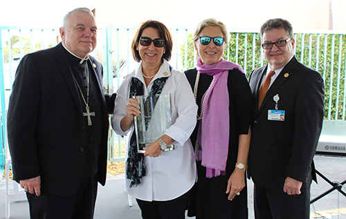 During its 20th anniversary celebration Jan. 26, Centro Mater West took the opportunity to recognize the Ortega family for their continuous support of the childcare center. From left, Archbishop Thomas Wenski, Maria Wollberg, Ana Ortega and J. Abilio Rodriguez, executive director of Centro Mater Child Care Services.