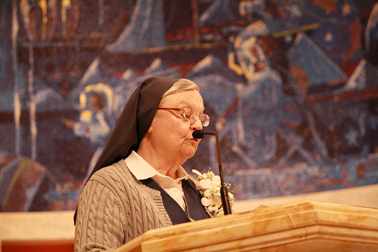 Sister Patricia Shaules, marking 50 years with the Daughters of St. Paul, proclaims one of the readings at the Mass.