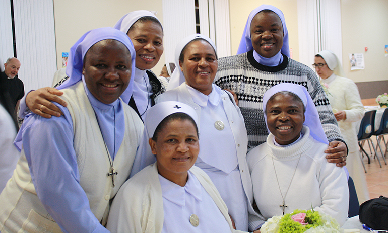 Enjoying the reception after the Mass for the World Day of Consecrated Life, from left, standing: Sisters Mary J. Madukwe and Marie Philo Cordis Chilaka from the Sisters of Jesus the Savior, Sister Euphenia Kimario from the Holy Spirit Sisters, and Sister Grace Mary Ezeimo from the Sisters of Jesus the Savior; seated, from left: Sister Mary S. Mushi from the Holy Spirit Sisters, and Sister Mary Chibunman Ogam from the Daughters of Mary, Mother of Mercy.