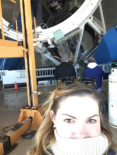 Immaculate Conception School science teacher Bianca Acosta gets up close with the Mayall Telescope located in the Kitt Peak National Observatory in Tuscon, Arizona.