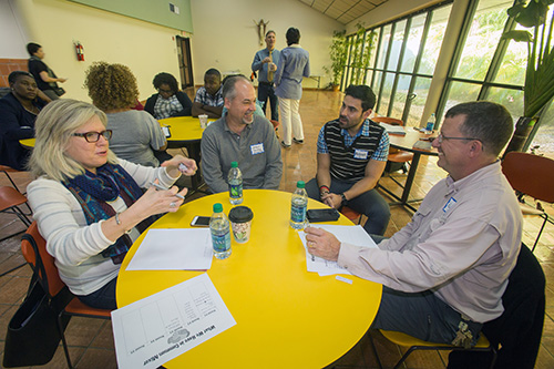 Annabel Sanchez, left, of Prince of Peace Parish, discusses a topic with those at her table, from left: Michael Sanchez, Prince of Peace, Gustavo Mejia, St. Joseph, and Rafael Mendez, Prince of Peace.