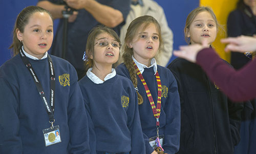 St. Anthony School choir members Samantha Bishop, 9, Erin Hoover, 9, Elena Ramos-Alvarez, 8, and Kate Manion, 8, sing during the dedication ceremony.