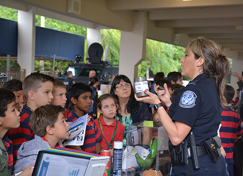 An officer from U.S. Customs and Border Protection shows St. Mark students some of the food items that cannot be brought into the U.S.