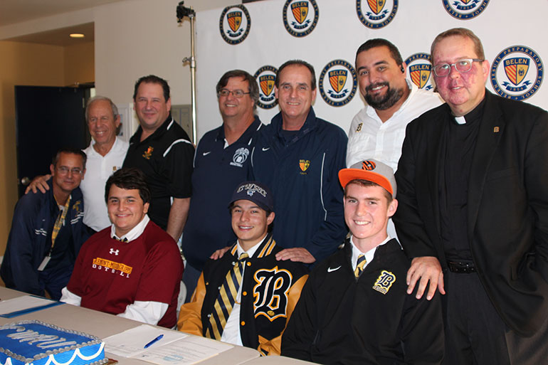 Football players Pablo Venegas, signed to Claremont McKenna College, Mario Robaina, Case Western Reserve University, and Tavish Rice, Princeton University pose with (back row): Belen Assistant Football Coach Eddie Fraga, Athletic Director Carlos Barquin, Assistant Football Coach Augusto Venegas, Angel Aparicio, Head Coach Richard Stuart, Assistant Coach Barney Flores and School President Jesuit Father Guillermo M. García-Tuñón.