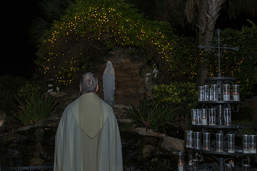 Msgr. Kenneth Schwanger, pastor of Our Lady of Lourdes, concludes the pilgrimage in the parish's replica grotto of Lourdes.