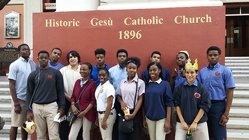 Pilgrims from Archbishop Curley Notre Dame pose outside Gesu, the oldest Catholic church Miami, which most of them had never visited.