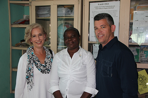 Ana and Eddy Garcia pose for a photo with Marie Louise Sylvestre, superintendent of schools for the Diocese of Port-de-Paix. She just needs one set of books for each grade, to make a copy for each teacher. They promised to raise the money to purchase it for her.