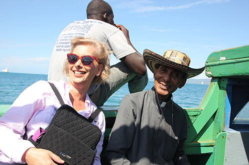 Ana Garcia poses for a photo with Bishop Pierre-Antoine Paolo of Port-de-Paix while sailing to Ile de la Tortue where he was dedicating a new church.