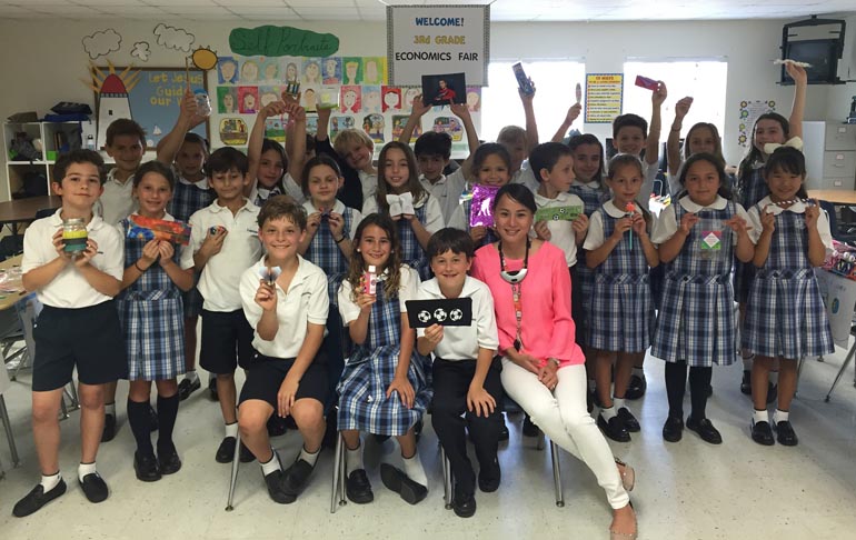 How is your supply and demand? St. Agnes Academy third graders pose for a photo with goodies that they made and sold at their Economcis Fair.