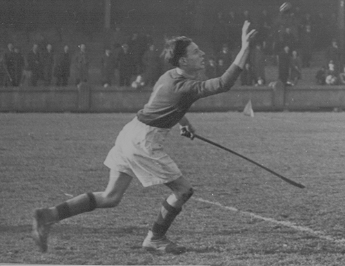 Before becoming a priest, Msgr. Noel Fogarty was a nationally-recognized hurling goalkeeper. Hurling is an ancient Irish sport, a cross between lacrosse and field hockey played with sticks called hurleys and balls known as sliotars. This photo was taken at the all-Ireland colleges semi-final in 1946. Although Msgr. Fogarty's side lost, the national newspaper praised his stellar goalkeeping.