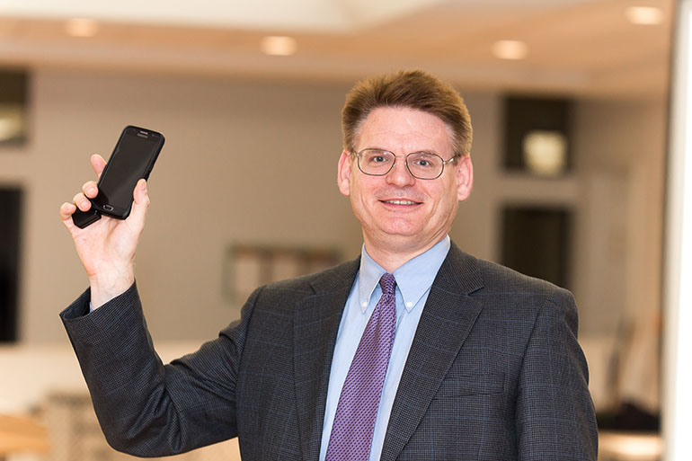 Philadelphia-based licensed clinical and family therapist Peter Kleponis holds up a smartphone - which he says young children should not have - after leading a workshop on internet pornography and addictions for some 70 parents and young adult men and teens gathered recently at St. Gregory the Great Parish in Plantation.