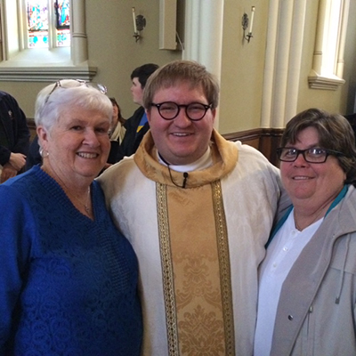 Holy Cross Father Matthew Hovde poses with his two youth minister-mentors, Susan Vanderwyden, left, and Valarie Lloyd, now dean of students at Msgr. Edward Pace High School in Miami.