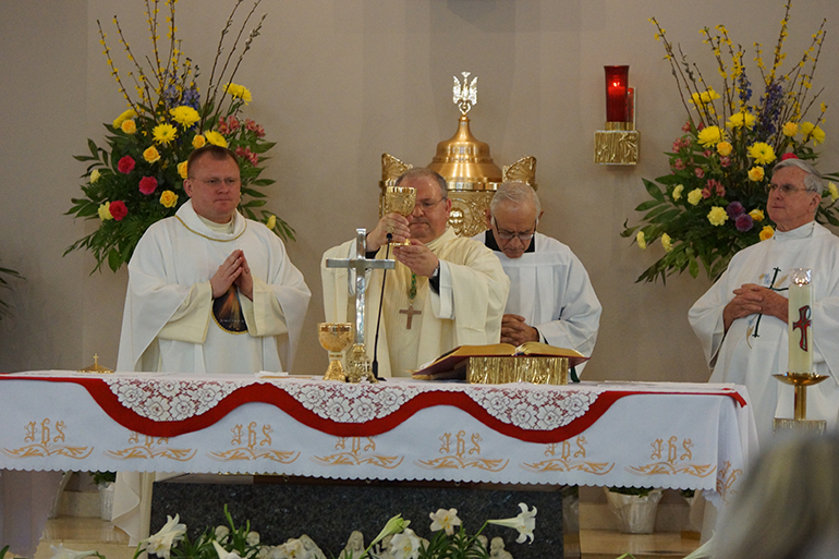 Miami Auxiliary Bishop Peter Baldacchino celebrates Mass at St. Coleman Parish on Divine Mercy Sunday. At left is Father Henryk Pawelec, St. Coleman's pastor, and at right is Father Gerald Morris, parochial vicar.
