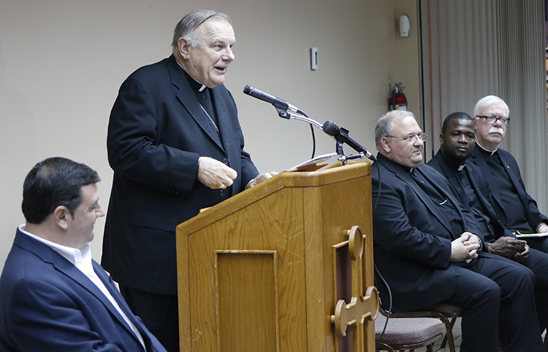 Archbishop Thomas Wenski speaks about The Joy of Love (Amoris Laetitia) at a press conference in the Pastoral Center April 8. Sitting at right are, from left, Auxiliary Bishop Peter Baldacchino, archdiocesan chancellor Msgr. Chanel Jeanty, and Msgr. Gregory Wielunski, judicial vicar in the Metropolitan Tribunal, which handles annulment cases.