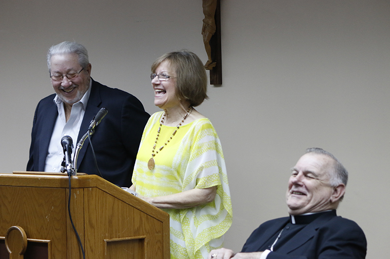 Felix Tirado and Mildred Ratcliffe, married nearly 50 years, laugh as Archbishop Thomas Wenski jokes "Que aguante!" (What patience!) after they were introduced. To which Ratcliffe replied, "Joyful aguante!"