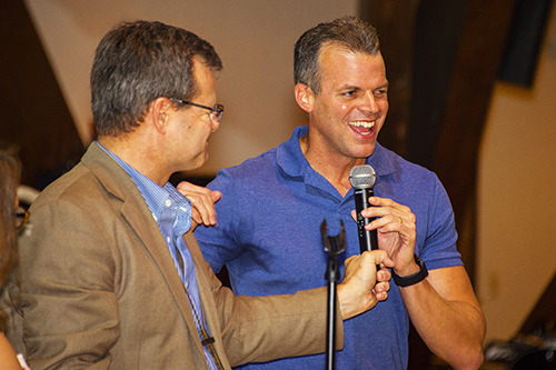 Pastor Keith Spencer of Trinity Lutheran Church hands the microphone to Broward County Mayor Marty Kiar.