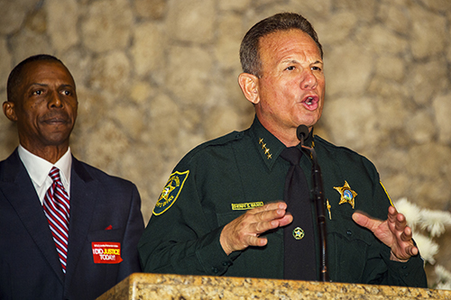 Pastor Michael Anderson of the New Jerusalem Baptist Church listens to Broward County Sheriff Scott Israel.