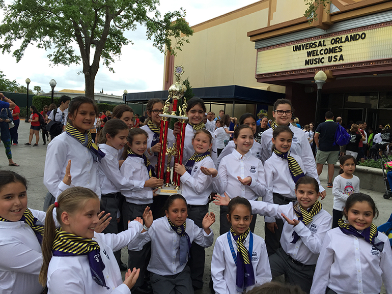 Members of St. Bonaventure's Children's Chorale hold up their Grand Champion trophy.