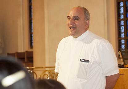 Father Roberto Cid, pastor of St. Patrick, Miami Beach, translates Sister Maria de Guadalupe Rodrigo's presentation from Spanish to English. The Argentine missionary, a member of the Congregation of the Incarnate Word, spoke at the parish April 20.