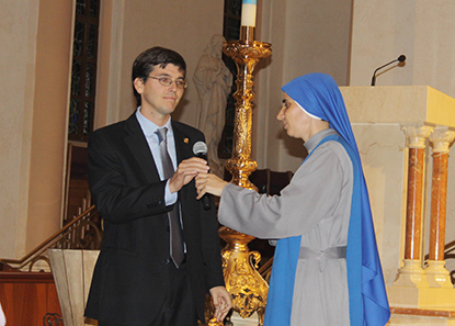 Sister Maria Guadalupe Rodrigo hands the microphone to Francisco Ruiz Guiñazú, of the Argentinian law offices Estudio Garrido, who are carrying out a campaign to help the persecuted Christians in the Middle East.