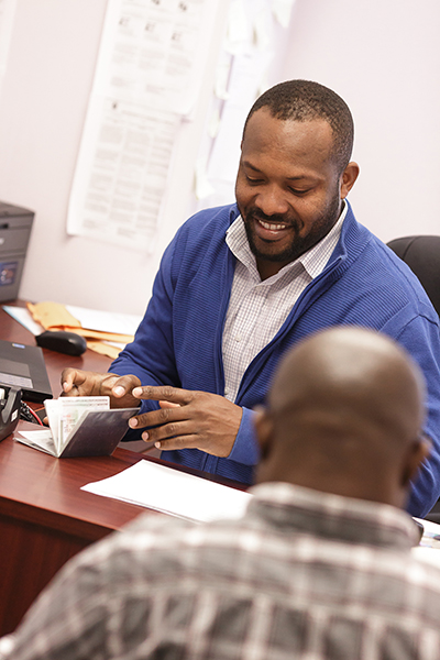 Cassy Pierre, a paralegal with Catholic Legal Services, meets with a client who is seeking asylum.