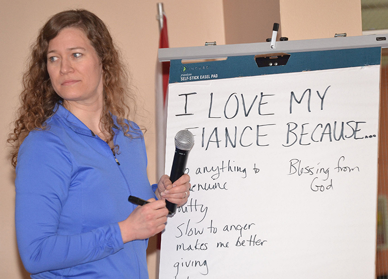 Cici Cooley writes down reasons given by participants for why they love their mates.