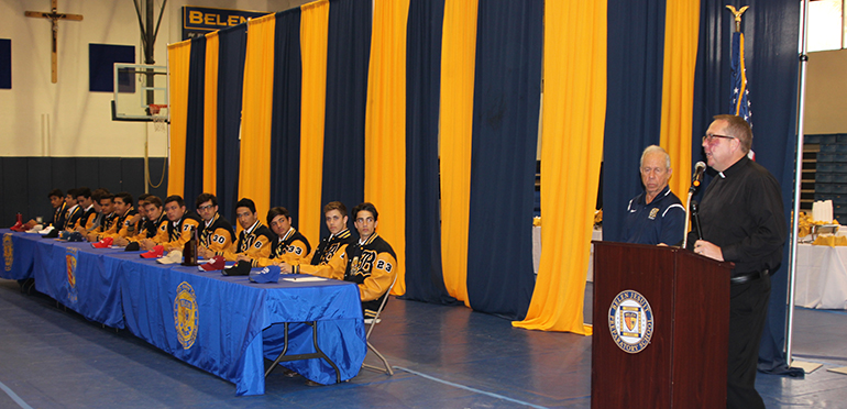 Fifteen Belen Jesuit student athletes sign their national letters of intent to play sports at the collegiate level during an assembly at the school. Speaking at right is the school's president, Jesuit Father Guillermo Garc&iacute;a-Tu&ntilde;&oacute;n, and Carlos Barquin, athletic director.