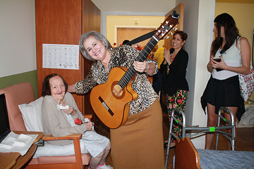 Waterford Nursing Home resident Maria Vazquez poses for a photo after being serenaded by musician Mirtha de la Torre. With them are St. Patrick Emmaus women Michelle Oyanguren and Andrea Giron.