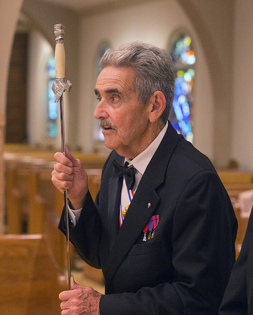 Raul Cendan, a Knight from St. Patrick Church in Miami Beach, holds his sword during the blessing of the swords ceremony.