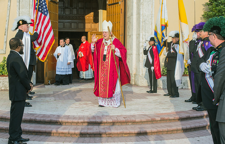 Archbishop Thomas Wenski greets Knights after the Mass outside St. Mary Cathedral.