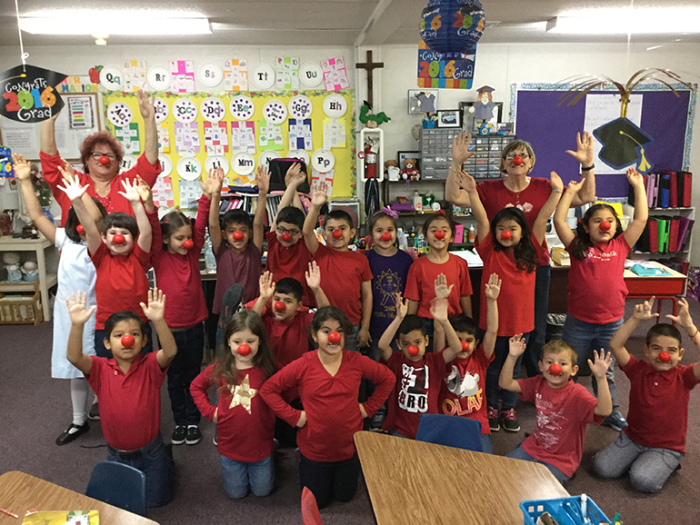 St. Michael kindergarten students and their teachers get in on the red-nose fun.
